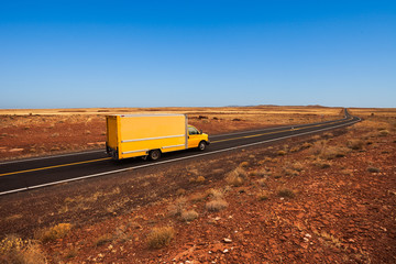 Yellow moving truck in the desert - 100037029