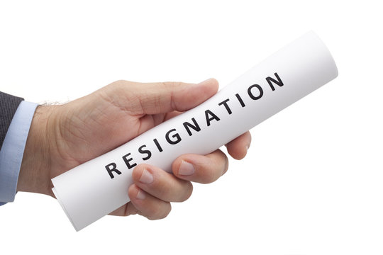 Man in a suit gives a rolled letter of resignation isolated on white background. Image with clipping path.