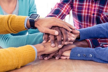 Business team stacking hands on desk