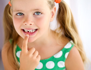 Little girl with falling tooth 