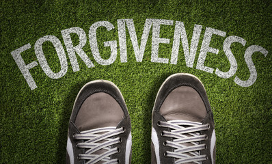Top View of Sneakers on the grass with the text: Forgiveness