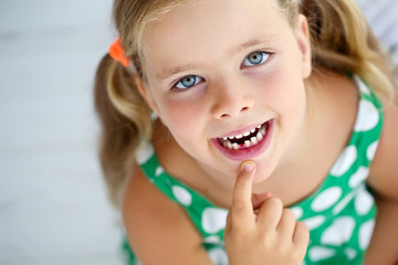 Little girl with falling tooth 