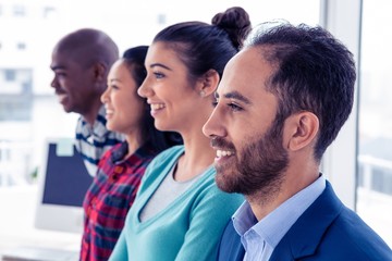Obraz premium Cheerful business team standing in row