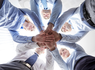 smiling group of businesspeople standing in circle