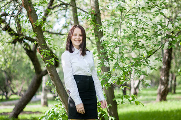 beautiful girl walks in the lush garden