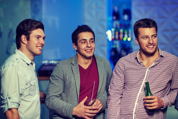 group of male friends with beer in nightclub