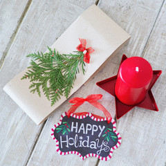 Winter decorations with Happy holidays sign on the wooden board