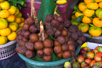 Fresh exotic tropical fruits for sale at an outdoor market.