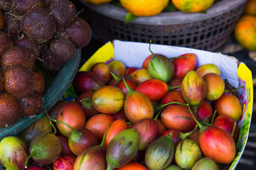 Fresh exotic tropical fruits for sale at an outdoor market.