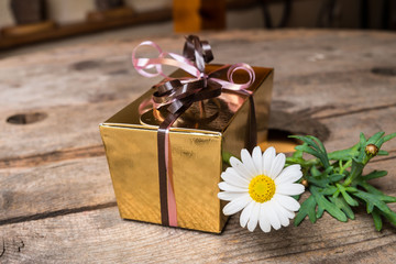 Fototapeta premium Present with flower on the table