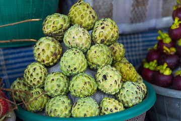 Fresh exotic tropical fruits for sale at an outdoor market.