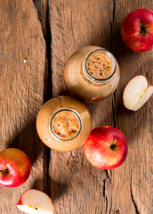 Apple juice and apples on wooden table. Nature apples 