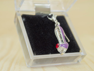 lovely crystal locket in box, blur wooden background