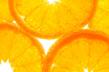 Fresh orange slice in water with bubbles on white background