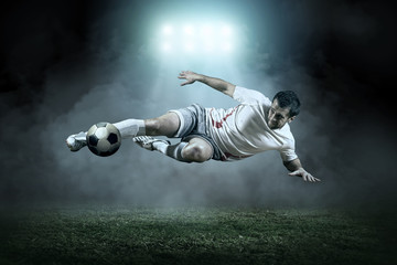 Soccer player with ball in action outdoors