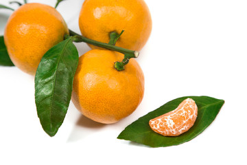 Fresh orange mandarine with leaf isolated on white background