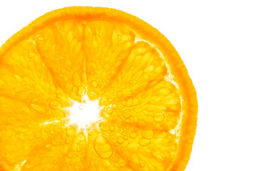 Fresh orange slice in water with bubbles on white background
