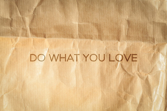 Do what you love. Inspiration card on crumpled paper background.