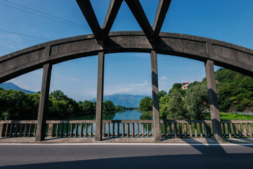 Bridge on Lago di Mezzola Lake. Water and mountains. Lombardy, Italy, Europe.