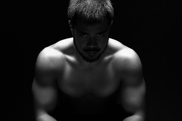 Fototapeta premium Portrait of a young muscular athlete