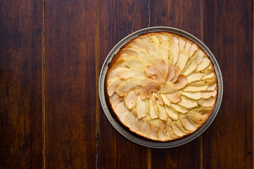 Apple pie over wooden background