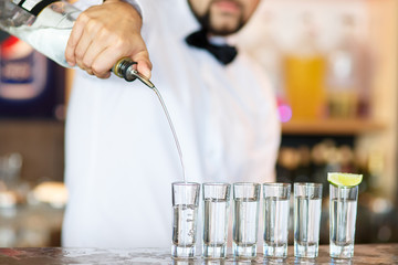 Barman at work, preparing cocktails.