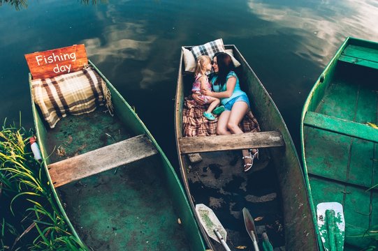 Mother And Daughter Together In A Boat Ride On The Lake.