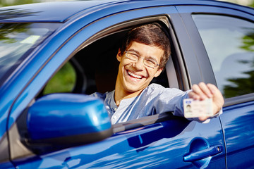 Guy in car with driving license