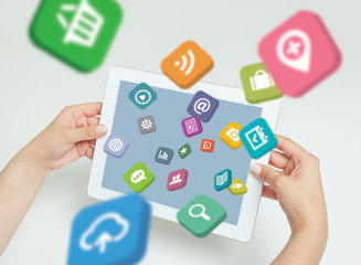 application icons fly off the tablet computer screen in hand