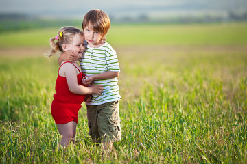 Happy kids in a green field 