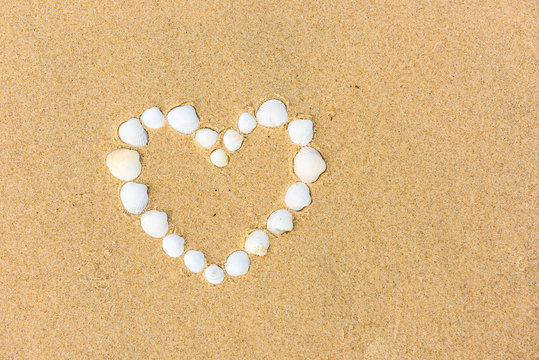 sea shell heart on the sand beach