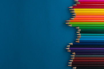 Colour pencils on blue background.