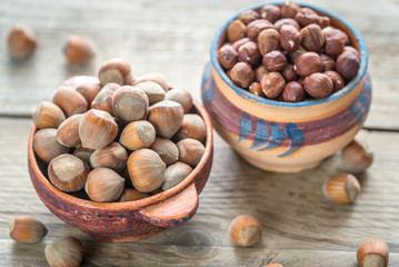 Rustic bowls of hazelnuts on the wooden table