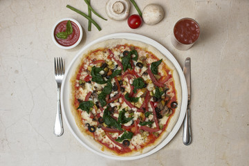 Shot of a pizza a white dish on a marble table