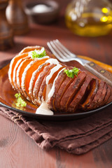 Baked hasselback potato with sour cream