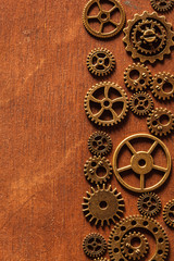 steampunk mechanical cogs gears wheels on wooden background