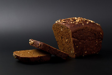 Black grain bread on a black
