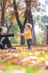 todler and mum playing in the park