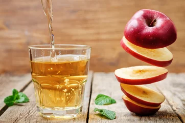 Wall murals Juice flying slices of apple and apple juice
