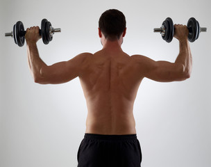 Fototapeta na wymiar Man lifting weights