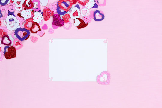 Blank white sign with collection of colorful hearts