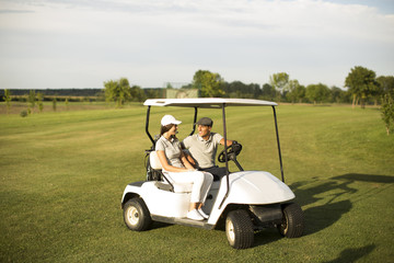 Young couple at golf cart