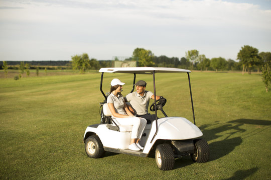 Young Couple At Golf Cart