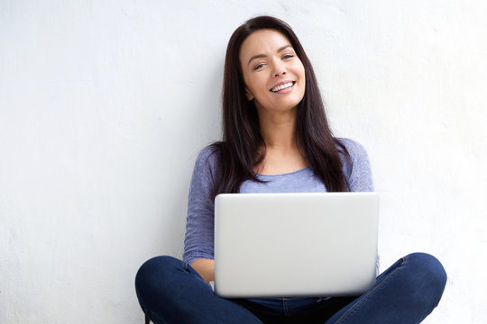 Relaxed female student using laptop