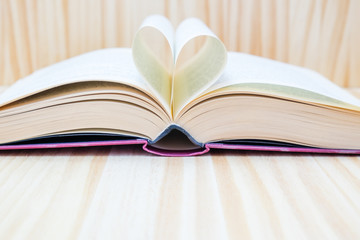 open book and forming a heart with their central leaves