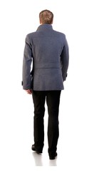 Back view of going  stylishly dressed business man in  gray coat