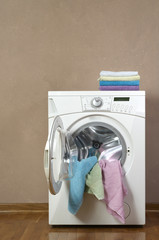Washing machine , White washing machine with towels on top, close-up