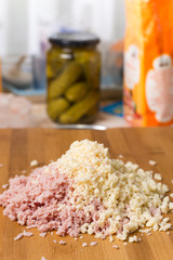 Chopped ham with chopped cheese on the wooden board