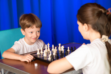 Children play a board game called chess.