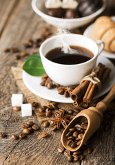 ground coffee in scoop and coffee beans on a wooden background,